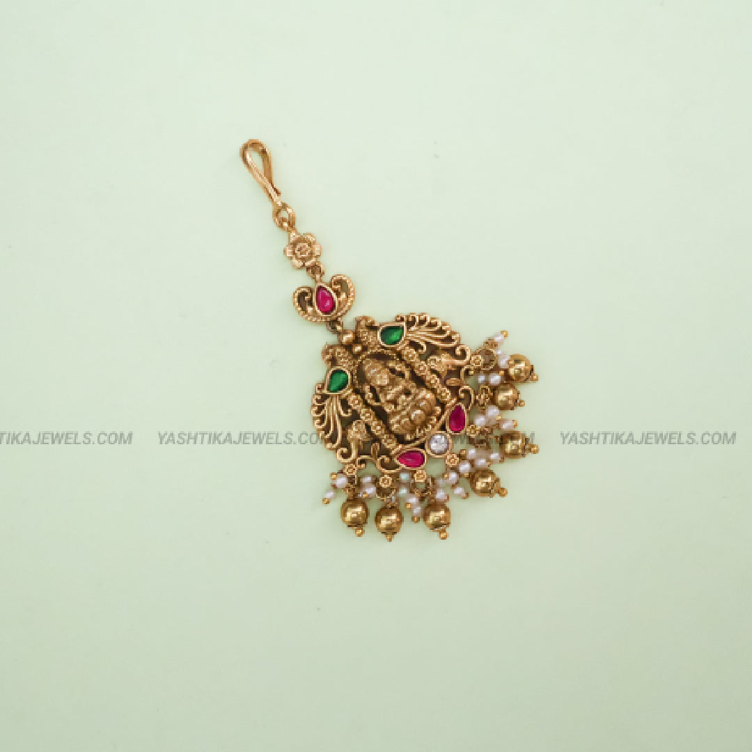 Antique gold brass Lakshmi peacock jadau maang tikka with kemp ruby-emerald stones and pearl bead drops - South Indian temple jewelry