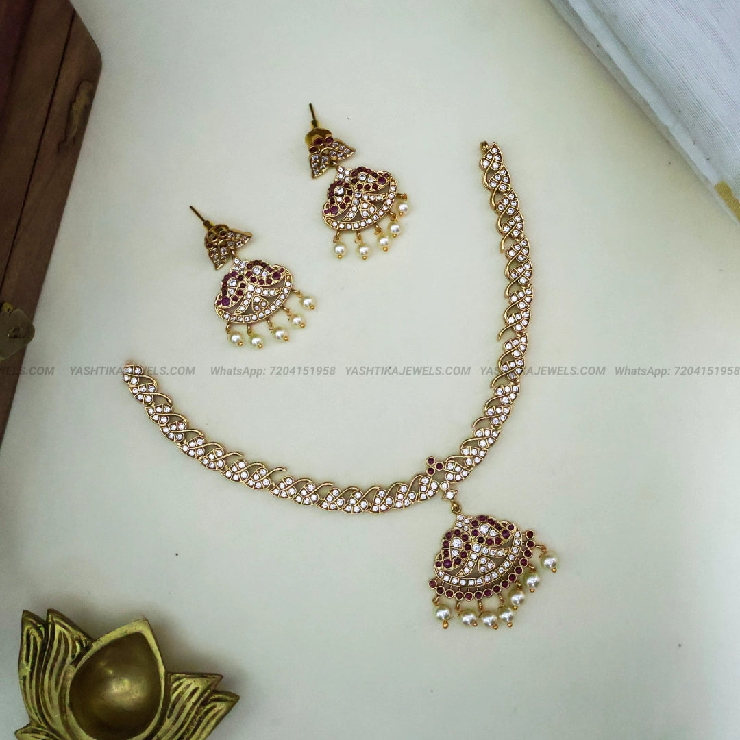 Vintage 90s attigai necklace with kundan-style stone work and pearl drops
Matching earrings for vintage attigai necklace set