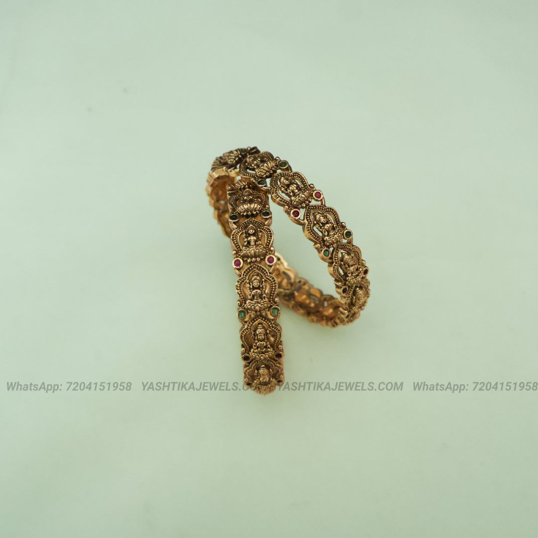 Antique gold goddess Lakshmi temple bangles pair with ruby and emerald stones
