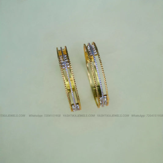 Gold tone kids bangles pair with white stone multi-line design