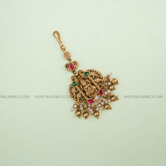 Antique gold brass Lakshmi peacock jadau maang tikka with kemp ruby-emerald stones and pearl bead drops - South Indian temple jewelry