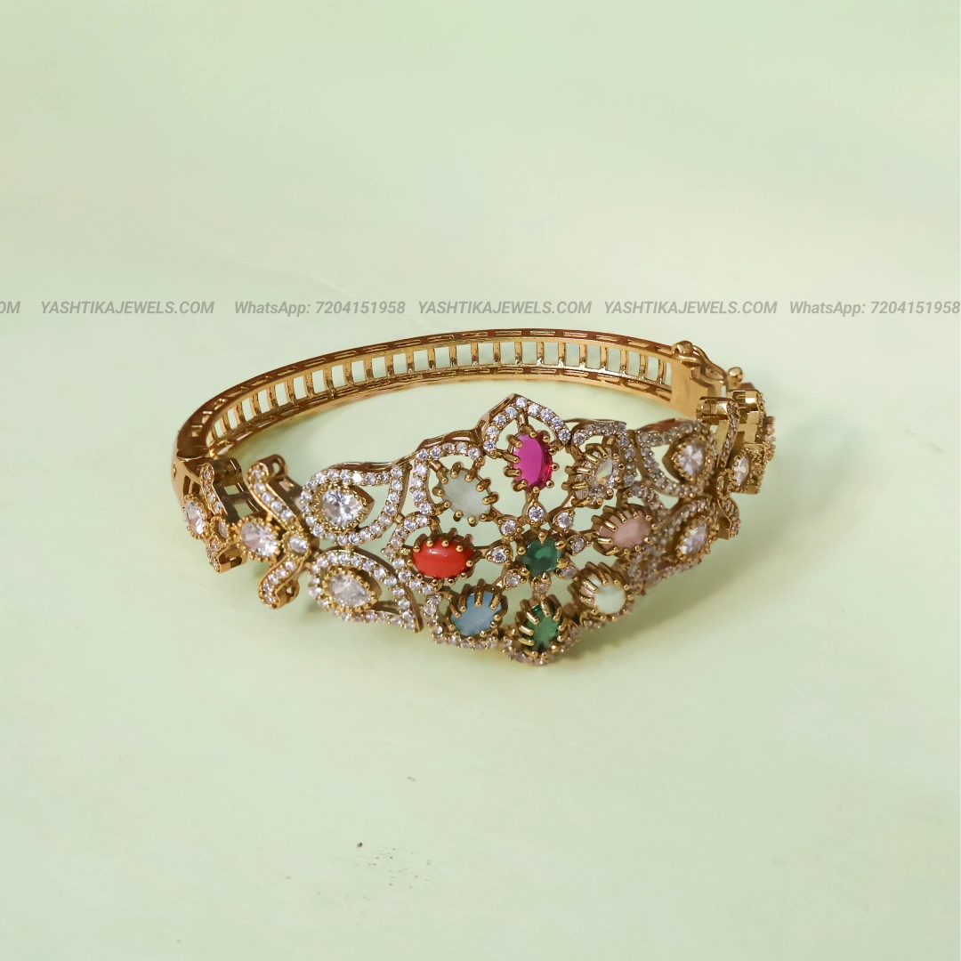 Gold-tone Navaratna and AD stone bracelet featuring multicoloured stones in an intricate floral design with sparkling white stone detailing.