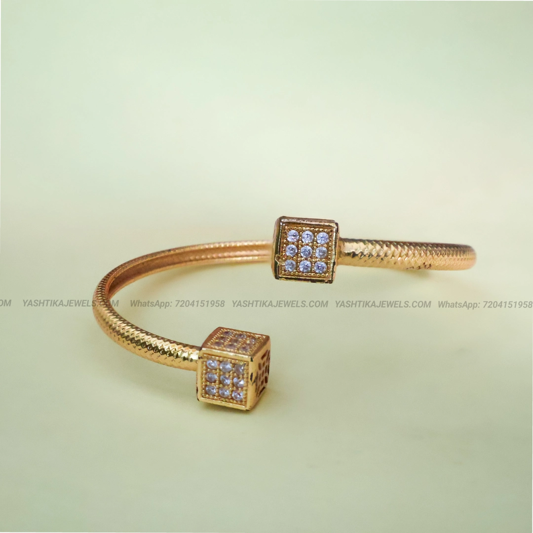 Gold-tone open cuff bracelet with square-shaped American Diamond AD stone embellishments for women.