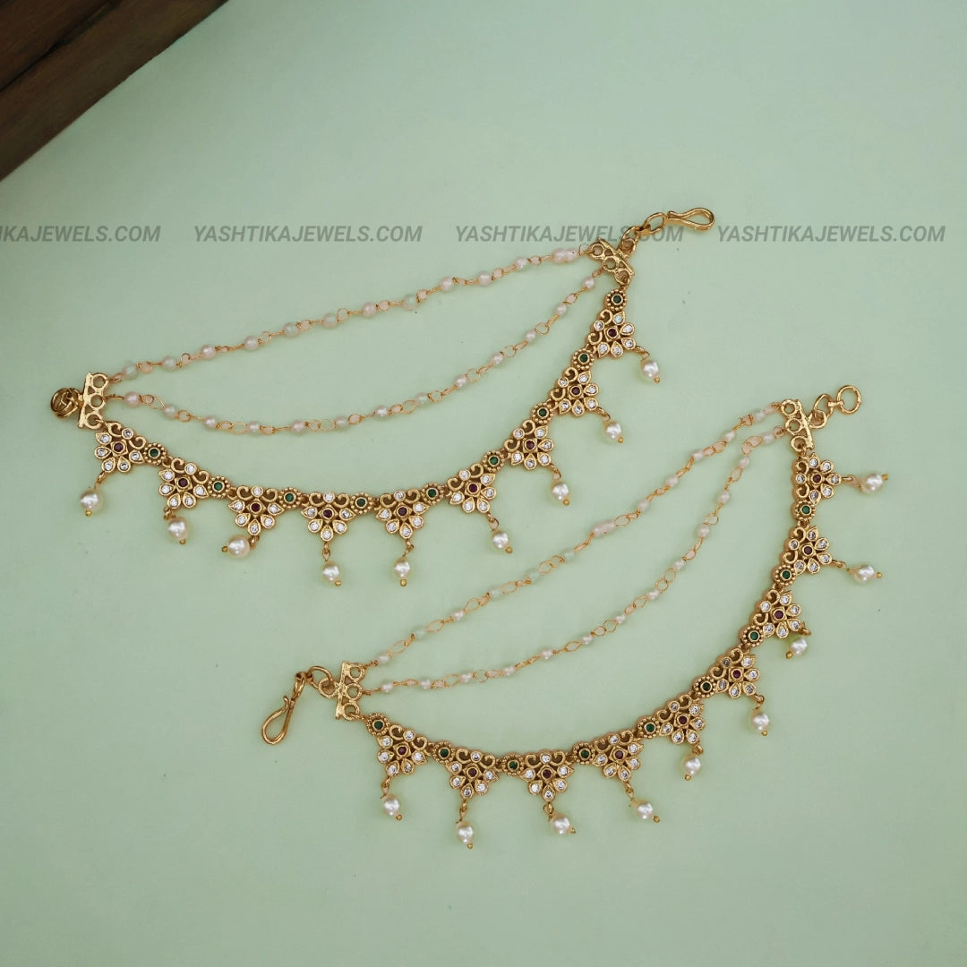 Gold-tone traditional ear chain with green and ruby-red stones, floral motifs, double chains and white pearl drops